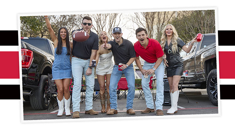 A group of young adults wearing Justin western boots are tailgaiting at a game.